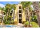 The condominium is surrounded by lush landscaping and swaying palm trees at 7705 Grand Estuary Trl # 202, Bradenton, FL 34212