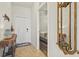 Welcoming foyer showcasing a stylish console table and mirror, leading to a bedroom view at 7705 Grand Estuary Trl # 202, Bradenton, FL 34212