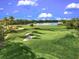 Beautiful golf course featuring green grass, sand traps, and a pond at 7705 Grand Estuary Trl # 202, Bradenton, FL 34212