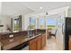 Bright kitchen featuring granite countertops, stainless steel appliances, and an adjacent dining area with scenic views at 7705 Grand Estuary Trl # 202, Bradenton, FL 34212