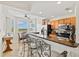 Modern kitchen with bar seating, ample counter space, and a view of the lush landscaping at 7705 Grand Estuary Trl # 202, Bradenton, FL 34212