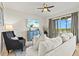 Cozy living room with large sliding doors opening to the balcony and an attractive ceiling fan at 7705 Grand Estuary Trl # 202, Bradenton, FL 34212