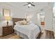 Comfortable main bedroom featuring hardwood floors, neutral decor, and an ensuite bathroom at 7705 Grand Estuary Trl # 202, Bradenton, FL 34212