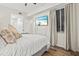 Tranquil bedroom featuring hardwood floors, a ceiling fan, a large window, and natural light at 7705 Grand Estuary Trl # 202, Bradenton, FL 34212