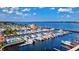 Expansive aerial view of the marina showcasing an array of boats, waterfront property, and a refreshing swimming pool at 7705 Grand Estuary Trl # 202, Bradenton, FL 34212