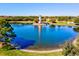 Picturesque pond featuring a charming gazebo and palm trees, creating a serene and inviting atmosphere at 7705 Grand Estuary Trl # 202, Bradenton, FL 34212