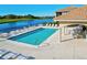 A refreshing pool with lounge chairs and tables under a covered patio, offering a perfect spot for relaxation at 7705 Grand Estuary Trl # 202, Bradenton, FL 34212