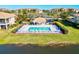 Stunning aerial view of a pristine pool with a charming gazebo, surrounded by lush landscaping and tranquil waters at 7705 Grand Estuary Trl # 202, Bradenton, FL 34212