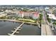 Stunning aerial view of waterfront condo featuring lush landscaping, community area, pier, and water access at 808 3Rd W Ave # 203, Bradenton, FL 34205