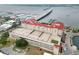 A stunning aerial view showcases the condo's rooftop tennis and basketball courts with city and water views at 808 3Rd W Ave # 203, Bradenton, FL 34205