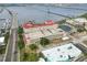 The aerial shot shows the condo's proximity to the water, bridge, and rooftop sports amenities at 808 3Rd W Ave # 203, Bradenton, FL 34205