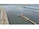 Aerial view of waterfront with bridges, with pier and boat sailing along the coast at 808 3Rd W Ave # 203, Bradenton, FL 34205