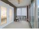 Private balcony has tranquil courtyard view, ceiling fan, and glass doors that lead to the bedroom at 808 3Rd W Ave # 203, Bradenton, FL 34205