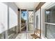 Outdoor balcony featuring sliding glass doors, a wicker chair, and views of the outdoors at 808 3Rd W Ave # 203, Bradenton, FL 34205