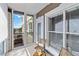 Outdoor balcony featuring sliding glass doors, stylish seating, and views at 808 3Rd W Ave # 203, Bradenton, FL 34205