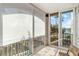 Relaxing balcony featuring views, sliding glass doors, and a cozy seating area at 808 3Rd W Ave # 203, Bradenton, FL 34205