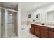 Bright bathroom boasts double vanities with granite counters, soaking tub, and glass enclosed walk-in shower at 808 3Rd W Ave # 203, Bradenton, FL 34205
