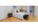 Bright bedroom features a queen bed, wood floors, and a glass sliding door at 808 3Rd W Ave # 203, Bradenton, FL 34205