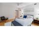 Bright bedroom features a ceiling fan, light hardwood floors, and a queen-sized bed with throw pillows and blanket at 808 3Rd W Ave # 203, Bradenton, FL 34205