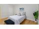 Bright bedroom features a queen bed, wood floors, and white walls at 808 3Rd W Ave # 203, Bradenton, FL 34205
