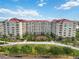 Front exterior of luxury apartments featuring beautiful trees and landscaping at 808 3Rd W Ave # 203, Bradenton, FL 34205