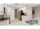 Well-lit kitchen featuring modern appliances, granite countertops, and white cabinetry, leading to hallway at 808 3Rd W Ave # 203, Bradenton, FL 34205
