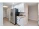 Bright kitchen space with stainless steel appliances and granite countertops, next to hallway at 808 3Rd W Ave # 203, Bradenton, FL 34205