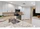 Well-lit kitchen featuring modern appliances, granite countertops, and white cabinetry at 808 3Rd W Ave # 203, Bradenton, FL 34205