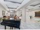 Elegant lobby with high ceilings, marble floors, comfortable seating, and a grand piano for a welcoming ambiance at 808 3Rd W Ave # 203, Bradenton, FL 34205