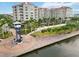 An elevated perspective shows the Riverwalk tower, showcasing its landscaped walkways, seating, and condo architecture at 808 3Rd W Ave # 203, Bradenton, FL 34205