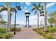 Scenic Riverwalk view with palm trees, a central sign, and a glimpse of the water for a relaxing outdoor experience at 808 3Rd W Ave # 203, Bradenton, FL 34205
