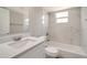 This bathroom features a shower and tub combo, decorative tile and a white vanity at 8308 Pelican Rd, Englewood, FL 34224