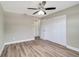 Spacious bedroom features hard-wood flooring, ceiling fan, and large closet at 8308 Pelican Rd, Englewood, FL 34224