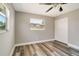 Comfortable bedroom featuring hard-wood flooring, outside views, and closet at 8308 Pelican Rd, Englewood, FL 34224
