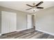 Bright bedroom with hard-wood flooring, large closet, and ceiling fan at 8308 Pelican Rd, Englewood, FL 34224