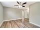 A spacious bedroom featuring modern flooring, a ceiling fan, and neutral paint palette at 8308 Pelican Rd, Englewood, FL 34224
