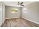 Comfortable bedroom with stylish flooring, windows with outside views and ceiling fan at 8308 Pelican Rd, Englewood, FL 34224