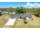 Aerial view of a single Gathering home with attached garage on a well manicured lawn at 8308 Pelican Rd, Englewood, FL 34224