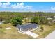 Aerial view of a single Gathering home with attached garage backing up to a wooded area at 8308 Pelican Rd, Englewood, FL 34224