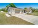 Home displaying a two car garage and a front entrance with updated lighting and landscaping at 8308 Pelican Rd, Englewood, FL 34224