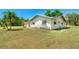 Angle view showing the side of the home with well maintained landscaping and nice curb appeal at 8308 Pelican Rd, Englewood, FL 34224