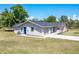 This ranch style home has attached garage, side door, and a long driveway at 8308 Pelican Rd, Englewood, FL 34224