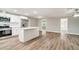 Open kitchen layout with stainless steel appliances, granite countertops, and wood flooring at 8308 Pelican Rd, Englewood, FL 34224