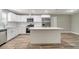 Well-lit kitchen featuring stainless steel appliances, granite countertops, and a kitchen island at 8308 Pelican Rd, Englewood, FL 34224