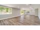 Large, well-lit living area featuring luxury vinyl plank flooring and sliding glass doors at 8308 Pelican Rd, Englewood, FL 34224