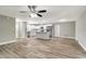 Spacious living area with wood-look flooring flowing into a modern kitchen with a center island at 8308 Pelican Rd, Englewood, FL 34224