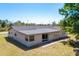 The rear exterior shows the home's roof, back yard, and a sliding glass door at 8308 Pelican Rd, Englewood, FL 34224