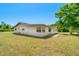 The rear exterior shows the home's roof, back yard, and surrounding neighborhood at 8308 Pelican Rd, Englewood, FL 34224