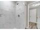 Bright shower featuring a sleek and modern design with marble style tiling at 8308 Pelican Rd, Englewood, FL 34224