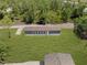 Aerial view of the home nestled within lush greenery and a sprawling lawn at 8414 Sweden Blvd, Punta Gorda, FL 33982